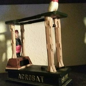 Antique acrobatics coin bank